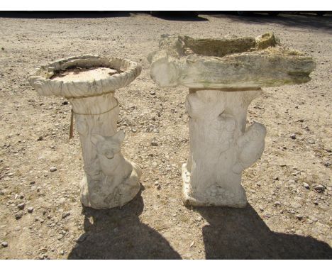 Two garden bird baths, one in the form of a tree trunk with owls, the other of a fox and cubs 