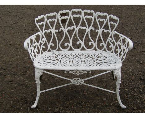 A small cast aluminium garden bench with decorative pierced framework on shaped supports, 95 cm wide 