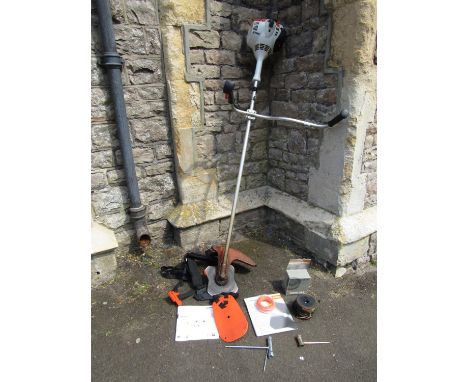 A Stihl petrol strimmer with 2 stroke engine 