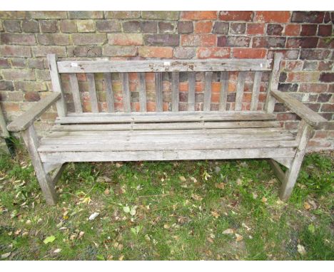 A weathered teakwood garden bench with slatted seat and back, 160cm 