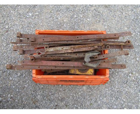 A quantity of salvaged ironware including early agricultural gate hinges, cow bell, drain covers, dog chains, etc 