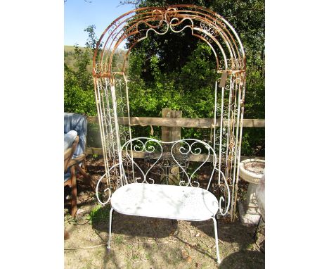 An arbour in metal with scrolled detail, 132 wide x 191cm high (af) together with metal terrace table of circular form and a 