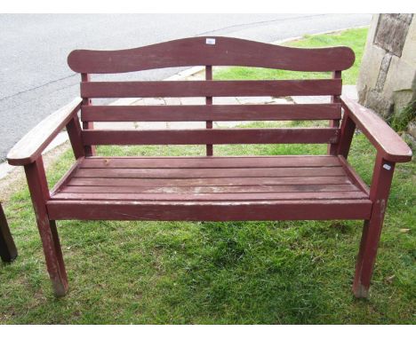 A small teakwood garden bench with slatted seat and back by Swan of Hattersley 