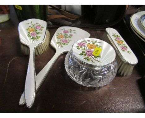 A hallmarked silver and enamel dressing table set, comprising four pieces decorated with flowers&nbsp;