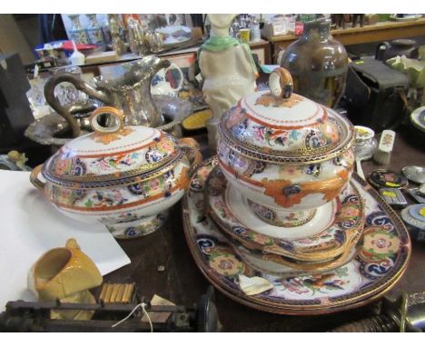 A pair of 19th century covered porcelain tureens and stands, together with matching ladle and pair of meat dishes, all decora