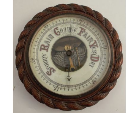 An oak framed circular barometer, with white enamel dial, diameter 9ins