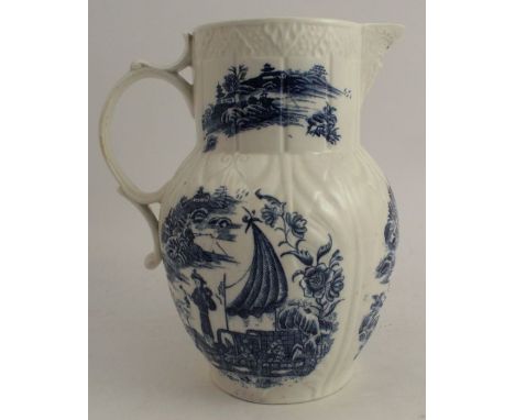 An 18th century Caughley cabbage leaf&nbsp; mask jug, decorated with a bandstand and cormorant fisherman pattern, height 9.5i