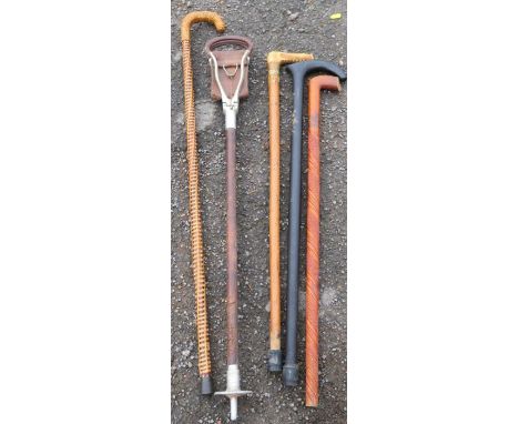 A Swaine-Brigg shooting stick, with leather seat, af, together with four walking sticks