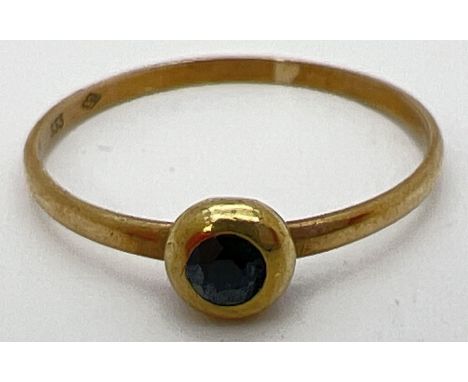 A small vintage 8ct gold ring with a bezel set sapphire. Stamped 333 inside band, ring size MÂ½. 