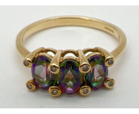 A 9ct yellow gold, mystic topaz and diamond trilogy ring. 3 oval cut mystic topaz stones (each approx. 5.5mm x 4mm) in a claw