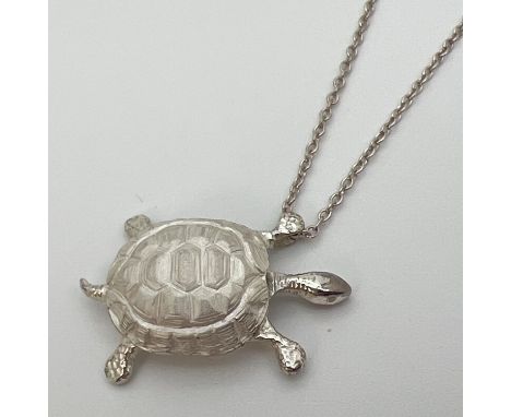 A silver pendant modelled as a tortoise on an 18" silver belcher chain with spring ring clasp. Reverse of pendant and chain f