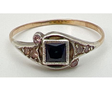 A small Art Deco dress ring with central square cut sapphire flanked by small pink stones in a decorative setting. Thin 9ct g