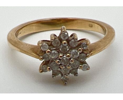 A 9ct gold and diamond cluster dress ring, set with 19 small diamonds. Fully hallmarked inside band (worn). Ring size NÂ½. 