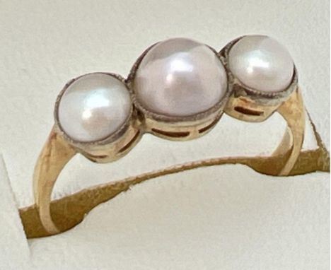 A vintage unmarked 18ct gold 3 stone pearl ring, tests as 18ct gold. Ring size N.