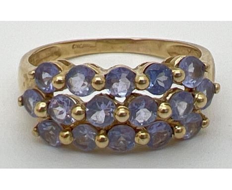 A 9ct yellow gold dress ring set with 3 rows of tanzanite stones. Stamped 9k and 375 inside band. Ring size NÂ½. 