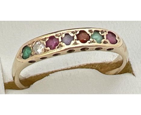 A 9ct gold multi gemstone eternity ring set with rubies, emeralds, diamond, garnet &amp; amethyst. Band unmarked but tests as