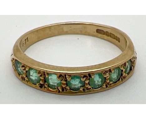 A vintage 9ct gold eternity ring set with 7 round cut emeralds. Fully hallmarked inside band. Ring size MÂ½. 