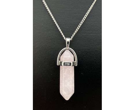 A rose quartz pointed hexagonal pendulum pendant in a white metal setting. On an 18" silver curb chain with spring ring clasp