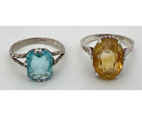 2 silver large stone set rings. An oval cut citrine (approx. 14mm x 10mm) together with a cushion cut pale blue stone. Both r