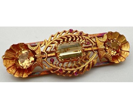 A vintage 24ct yellow gold brooch set with 3 large yellow topaz stones and small ruby cabochons. A bespoke made brooch with w