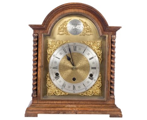 A 1920s oak-cased arch-top bracket clock, brass arch-top dial, silver chapter ring and Roman numerals, H35cm, with key and pe