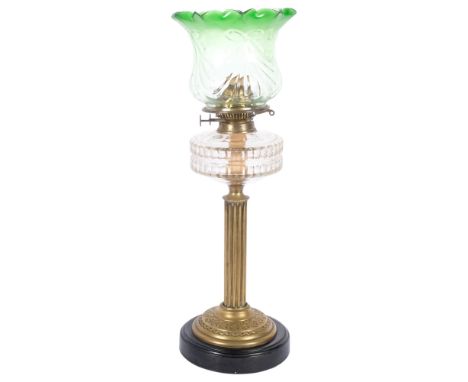 A Victorian brass oil lamp, with shaped green glass shade and glass font, brass fluted column and black ceramic base, H60cmGo