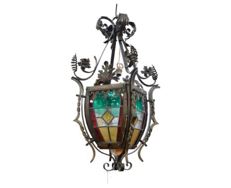 An impressive early 20th century wrought-iron ceiling lantern light fitting, with stained glass panels, drop approx 70cm Good