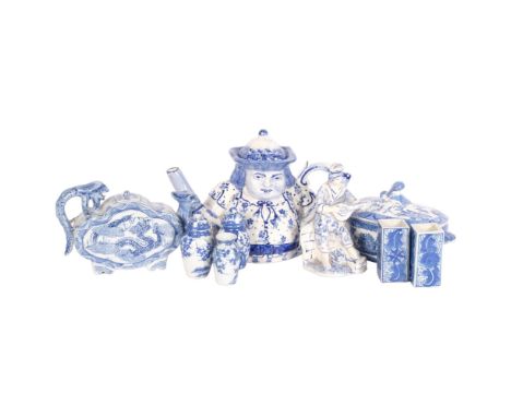 A quantity of blue and white Chinese ceramic ware, including a peg leg figural Toby jug style teapot, a 19th century English 