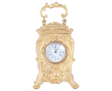 An ornate reproduction miniature gilt-metal carriage clock, with swing handle, height not including handle 7.5cm, with keyGoo