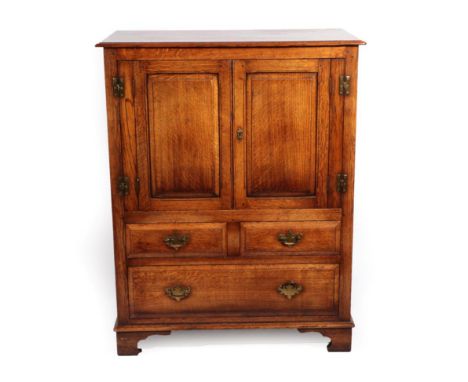 A Reproduction Oak Cupboard, with moulded cupboard doors above two short and one long drawer, on bracket feet, 91cm by 51cm b