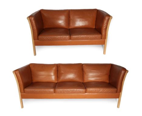 A Pair of 1970's Danish Stouby Sofas, covered in tan leather, comprising a three-seater sofa, with eight cushions, 201cm by 7