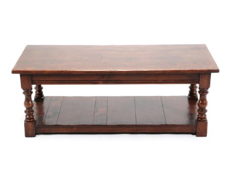 An Oak Rectangular Coffee Table, modern, on baluster turned legs joined by a shelf with block feet, 122cm by 56cm by 46cm