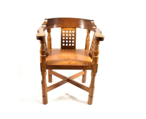 Mouseman: A Robert Thompson of Kilburn English Oak Monk's Chair, with curved back and shaped arms, over three lattice panels,