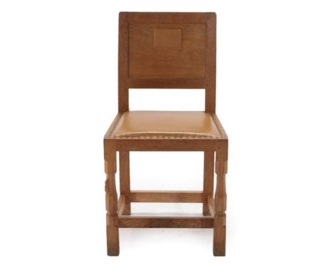 Mouseman: A Robert Thompson of Kilburn English Oak Panel Back Dining Chair, upholstered nail hide seat, on two octagonal fron