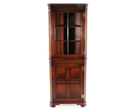 A Kumpers of Salisbury Oak Free-Standing Corner Cabinet, modern, the upper section with a door enclosing fixed shelves, the b