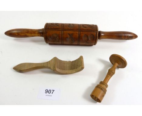 A Victorian wooden biscuit mould rolling pin, a butter curler and a butter stamp 