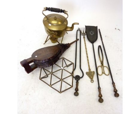 An Edwardian brass spirit kettle on stand and various fire side items including bellows and fireside set 