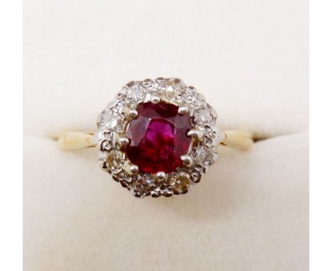 An 18 carat gold ruby and diamond cluster ring, size N 
