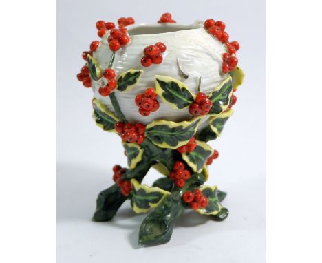 A Victorian porcelain vase in the form of a basket clad with holly branches, R mark to base, 13 cm tall 