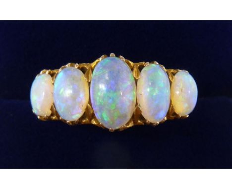 An 18 carat gold five stone opal ring, size O, 5.2g, unmarked 