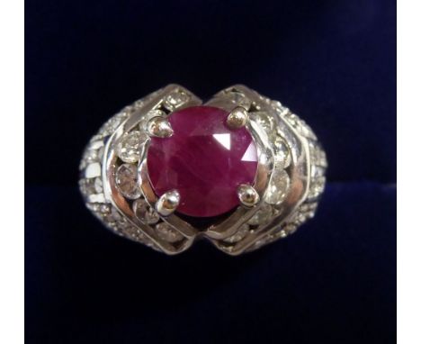 An 18 carat white gold ring set ruby on diamond set shoulders, size I, 8.6g 