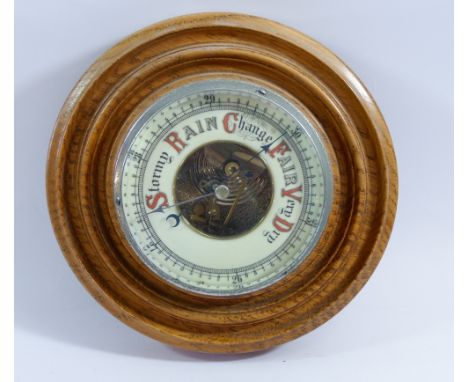 A light oak framed circular barometer 