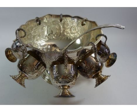 A silver plated large punch bowl 27cm diameter, with eight punch cups and ladle 