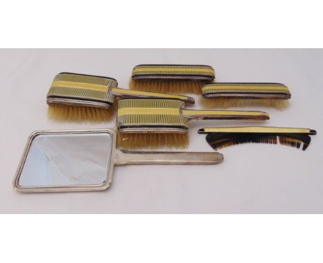 An Art Deco hallmarked silver and enamel dressing table hand mirror, hair and clothes brushes and a comb, A/F