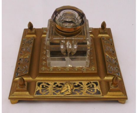 A Victorian cut glass and brass inkwell, the pierced square mount supporting detachable glass inkwell all on four bracket fee