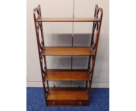 A four tier rectangular mahogany wall shelf with scroll pierced sides and a single drawer, 87.5 x 40.5 x 16.5cm