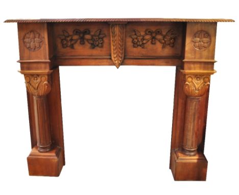 A 20th century wooden fire surround, carved foliate decoration and twin pilasters, 126 x 160cm.