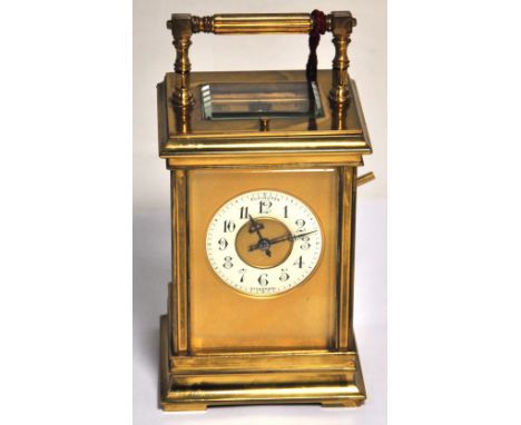 A late 19th century French brass carriage clock, the fluted hinged carrying handle above the lever escapement, repeating move