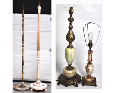 A gilt metal and onyx standard lamp, a further white painted standard lamp, each 154cm in height and two gilt metal and onyx 