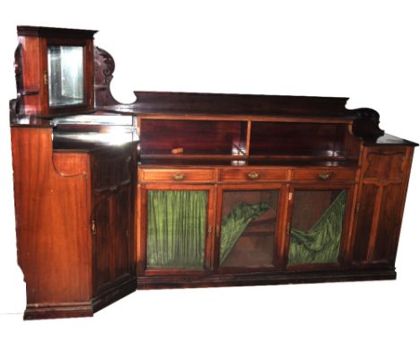 An unusual Edwardian mahogany bookcase, fitted with a mirrored corner section to the left hand side above panelled cupboard d